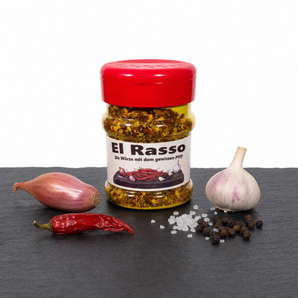 El Rasso Gewürzdose mit Chili, Knoblauch, Pfefferkörnern und Salz auf dunkler Fläche.