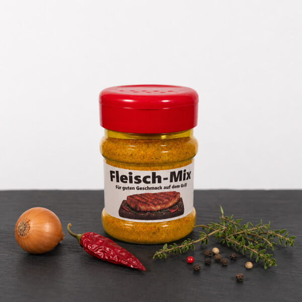 Fleisch‑Mix Gewürzdose mit Zwiebeln, Chili, Pfefferkörnern und Thymian auf dunkler Fläche.